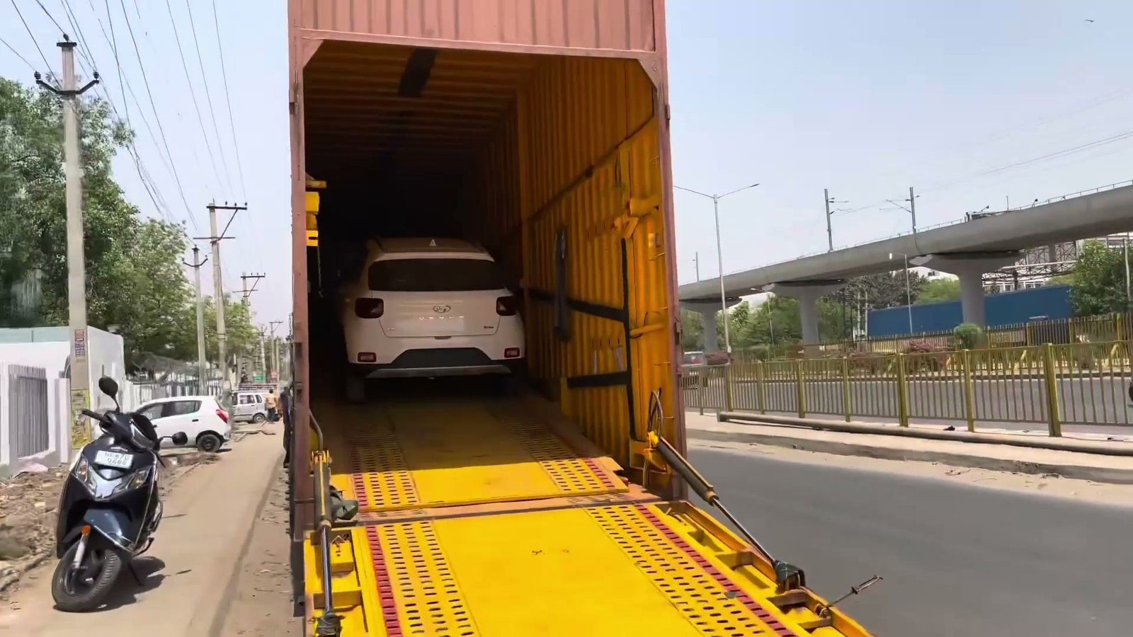 Enclosed hydraulic car carrier container truck loading car at Transport Nagar Patna terminal